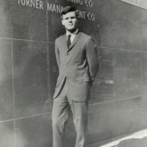 Ted Turner in front of Turner Advertising building