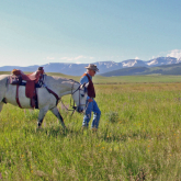 Ted Turner walking with horse